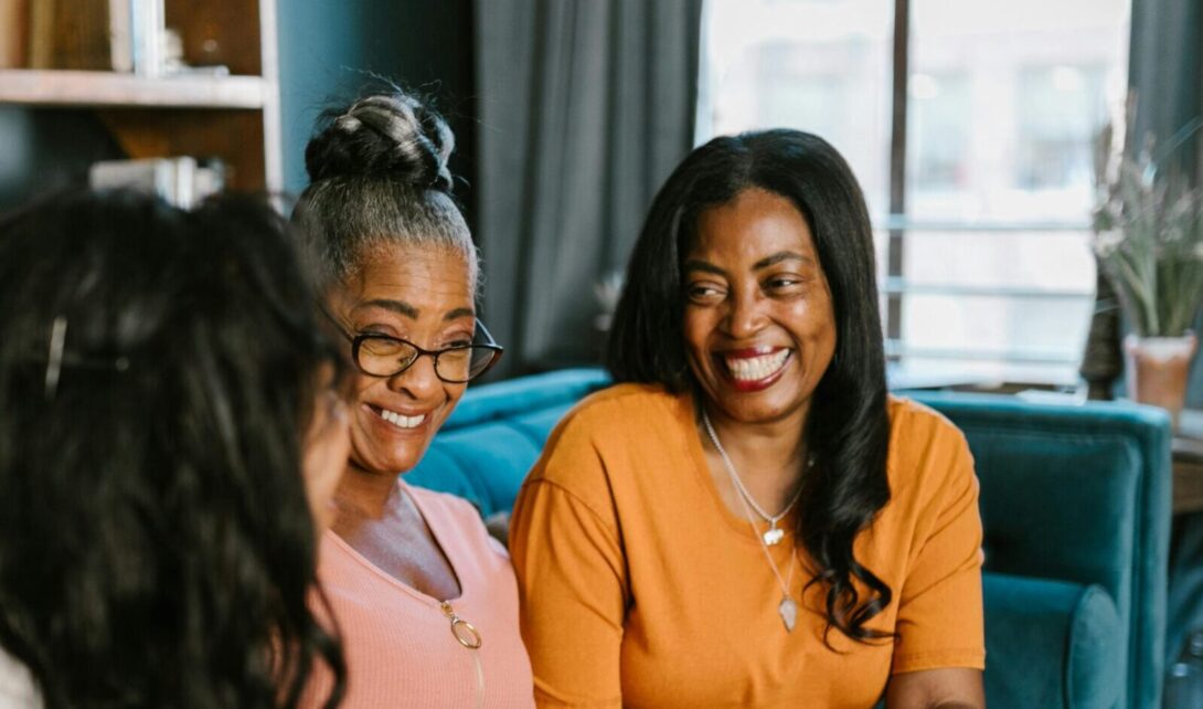 Adult women smiling in conversation